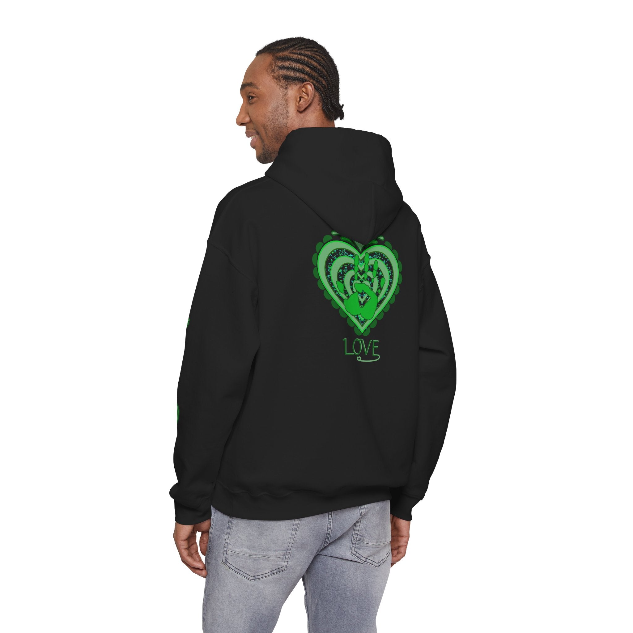 Person wearing a black hoodie with a green heart design on the back, standing against a white background.