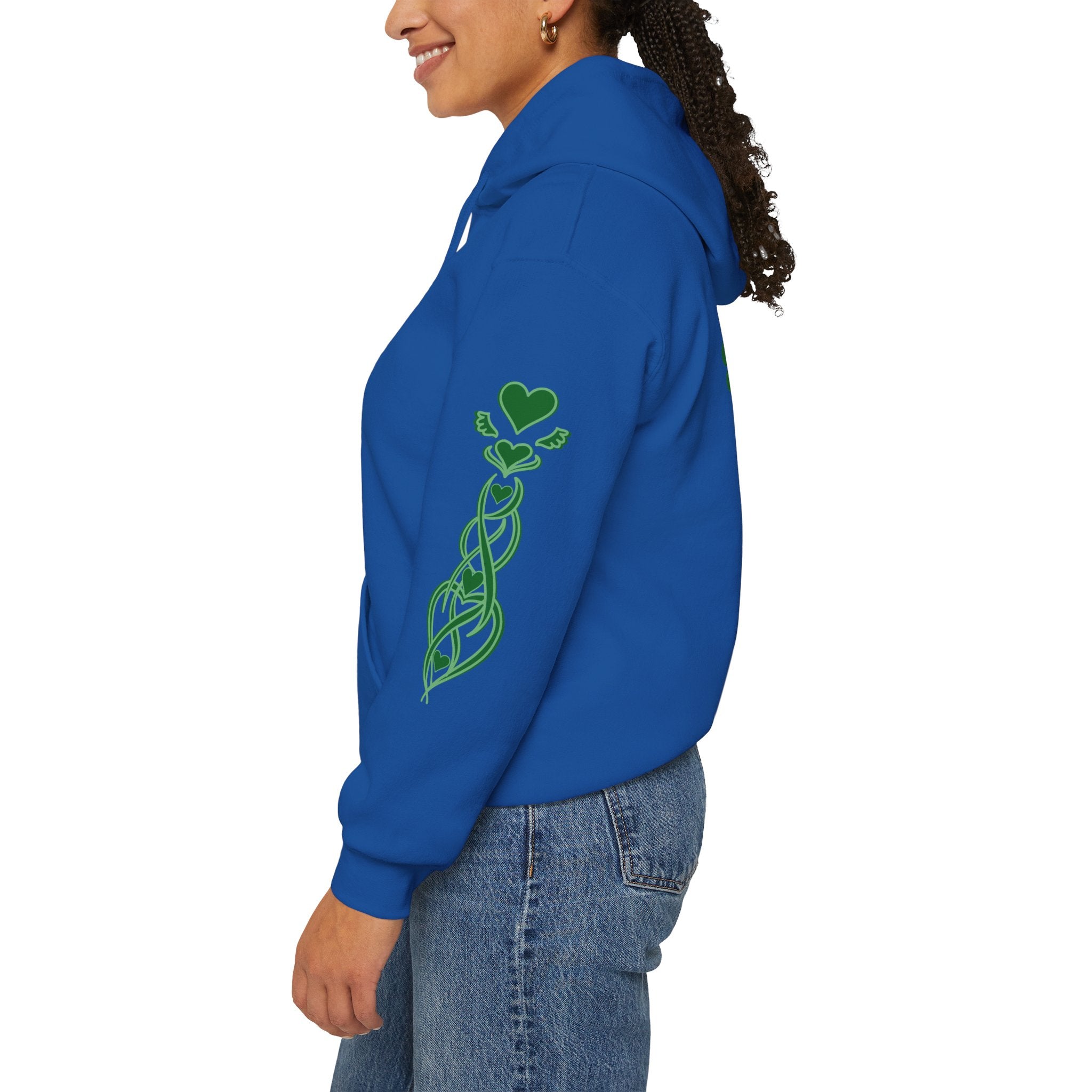 Person wearing a blue hoodie with green heart design