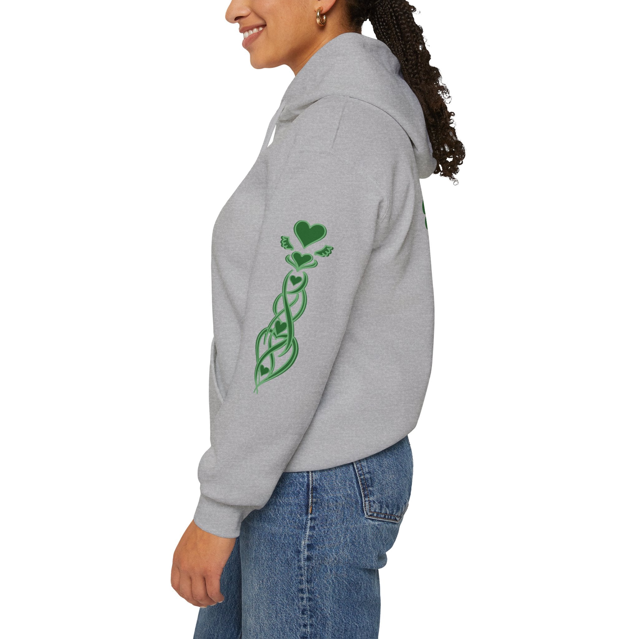 Person wearing a gray hoodie with green designs