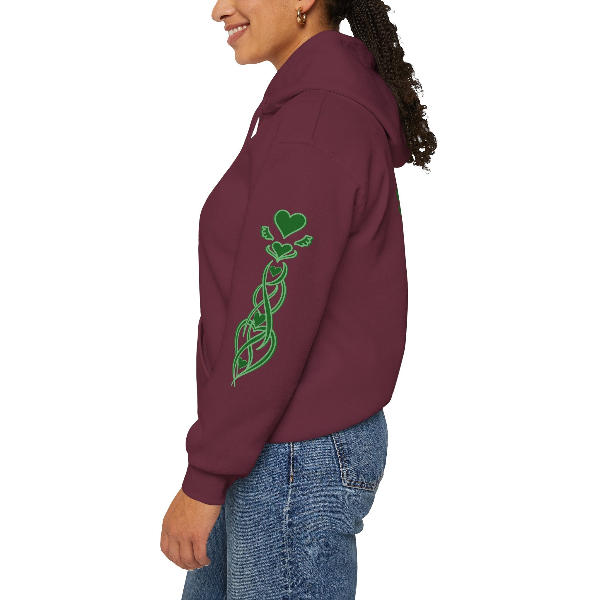 Person wearing a maroon hoodie with a green design on the back, standing against a white background.