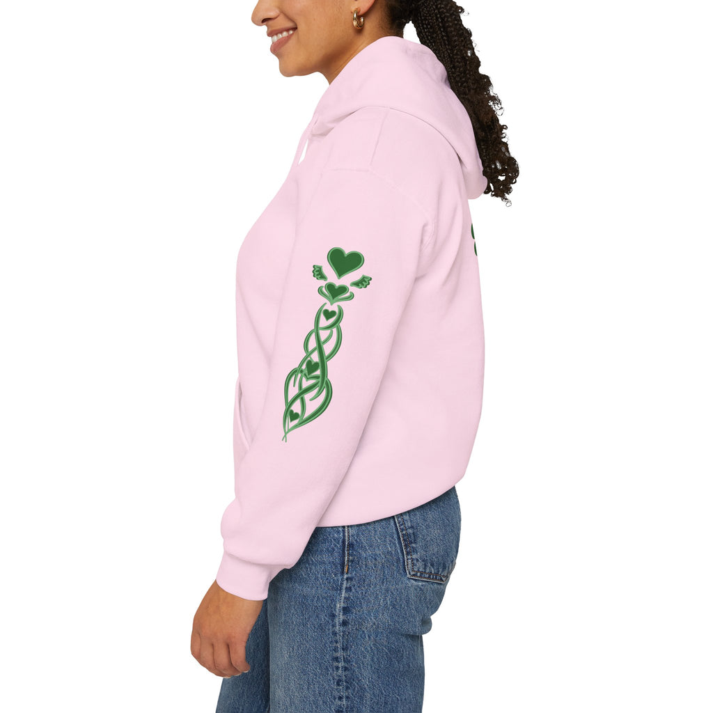 Person wearing a pink hoodie with a green graphic on the sleeve against a white background