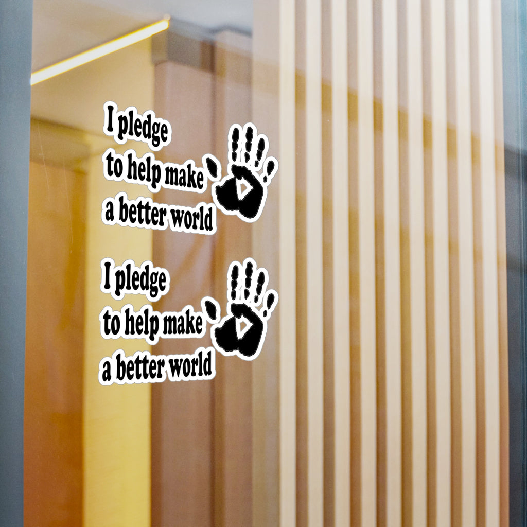Wall decal with handprints and text 'I pledge to help make a better world' on a glass door