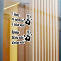 Wall decal with handprints and text 'I pledge to help make a better world' on a glass door