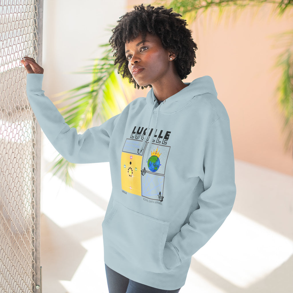 Person wearing a light blue hoodie with a Lucille graphic design and text, standing indoors with plants in the background.